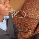 African woman member non-governmental organization NGO Mwai clients' hair blind