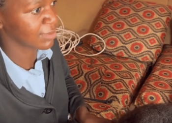 African woman member non-governmental organization NGO Mwai clients' hair blind