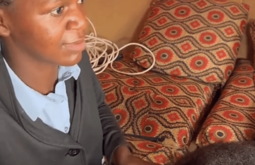 African woman member non-governmental organization NGO Mwai clients' hair blind